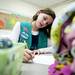 Girl scout Maggie Packard writes a letter to a New Hope Baptist Church blanket recipient on Tuesday, Jan. 22. The church says they are excited to receive these blankets. Daniel Brenner I AnnArbor.com